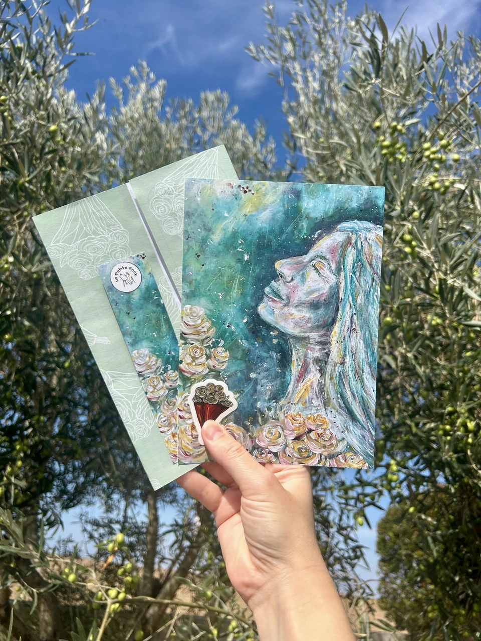 October Mailclub edition with the woman with flowers, letter and extras among olive trees
